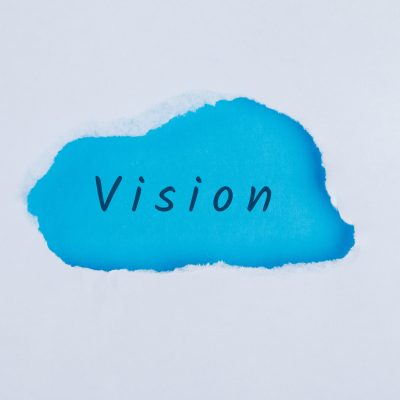 Marketing concept with vision word on blue and white background flat lay.
